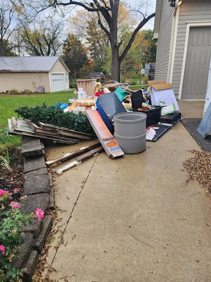 Dumpster being loaded with debris for 12 Yard Dumpster Rental in Warsaw